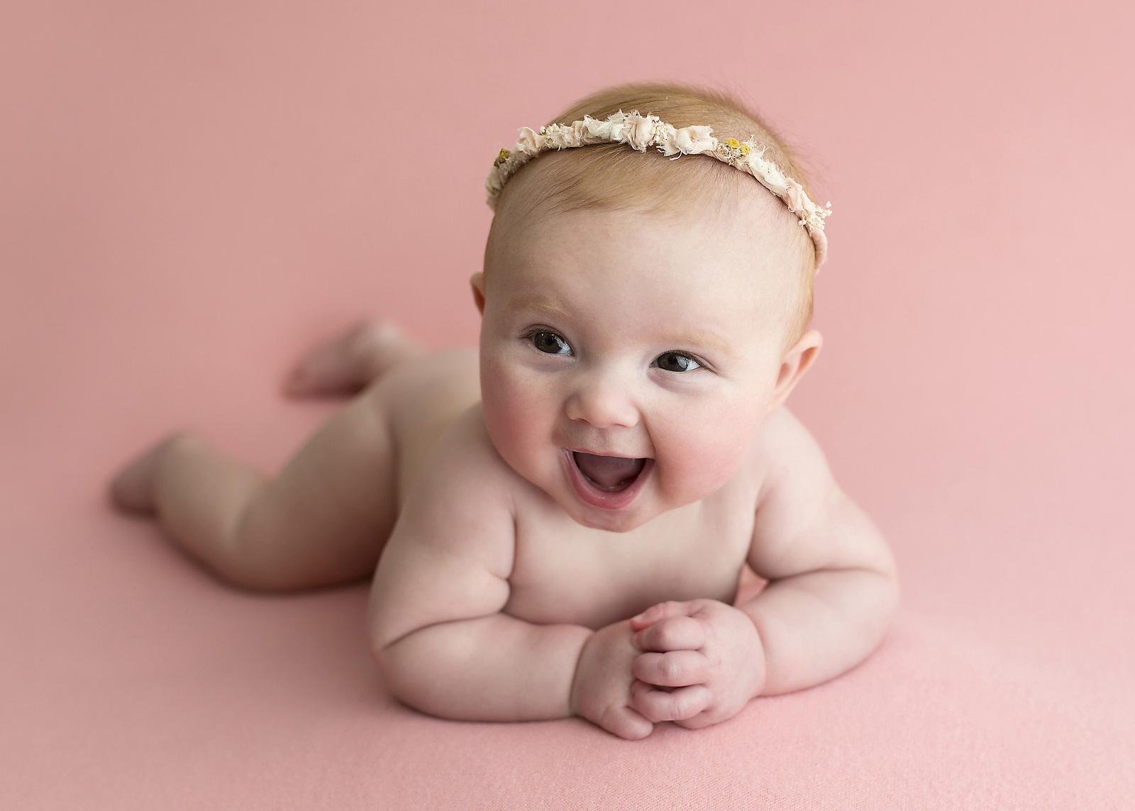 4 month girl laying on pink blanket naked tushie