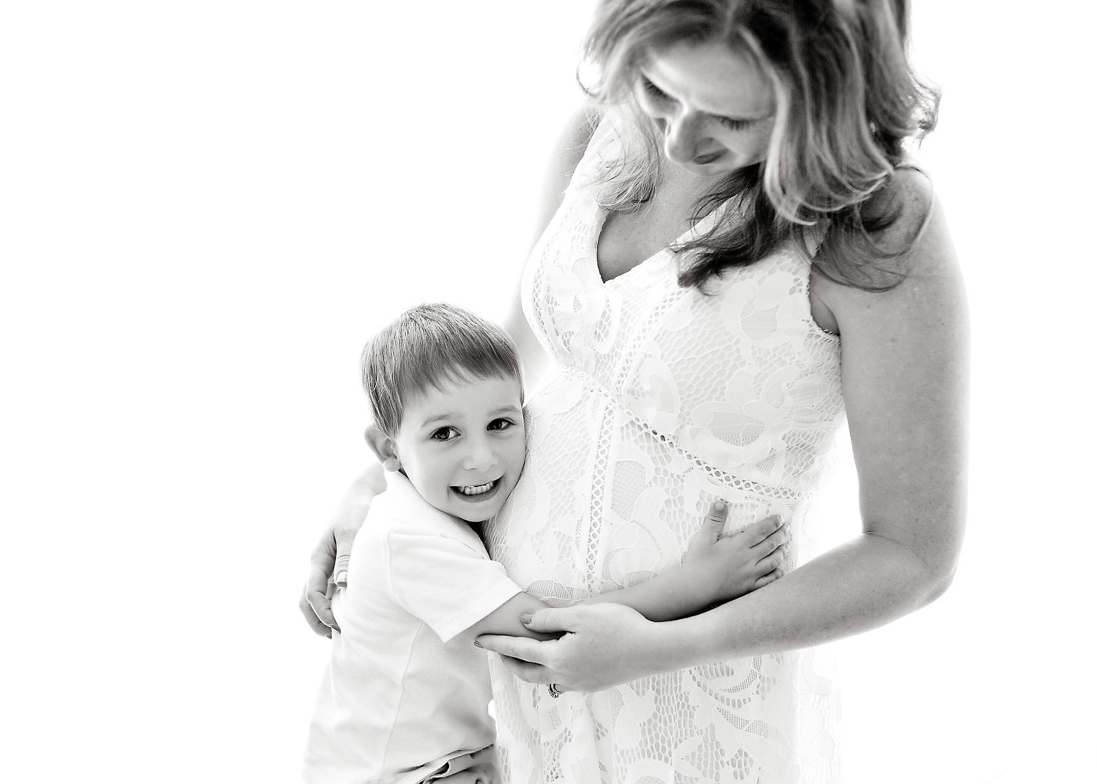 mother and son hugging backlit black white image