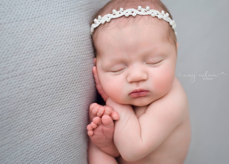 newborn girl photography on gray blanket